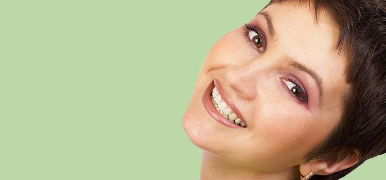 Attractive woman with short hair smiling and her head tilted to the side