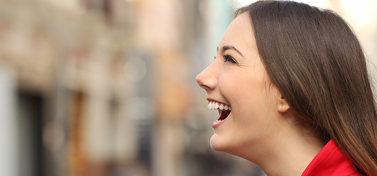 Profile of attractive young woman laughing