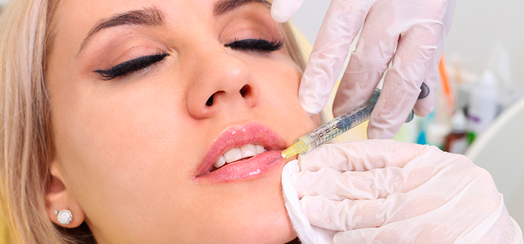 Woman getting Juvederm filler injected into lips