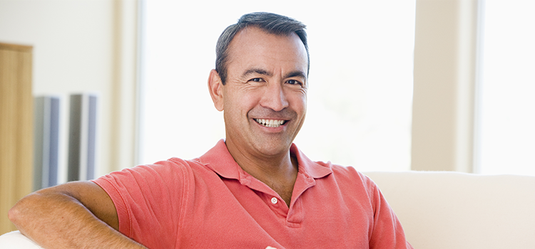 Handsome man in polo shirt smiling at camera