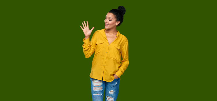Young woman in blouse and torn jeans holding up hand with 5 fingers