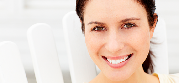 Brunette woman smiling looking at camera in closeup