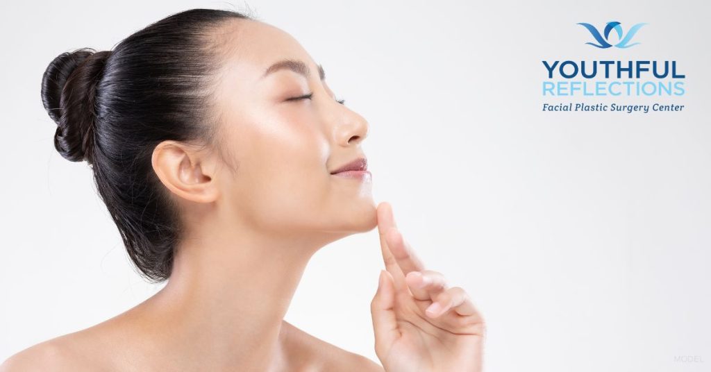 Woman touching her chin (model).