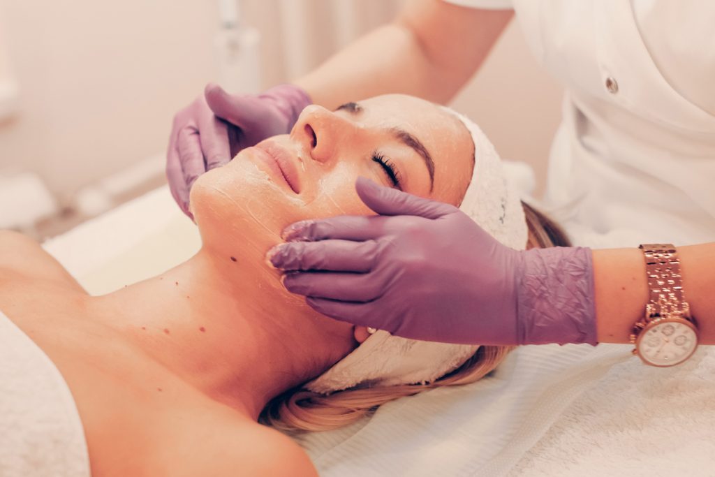 Woman lying on her back getting a facial