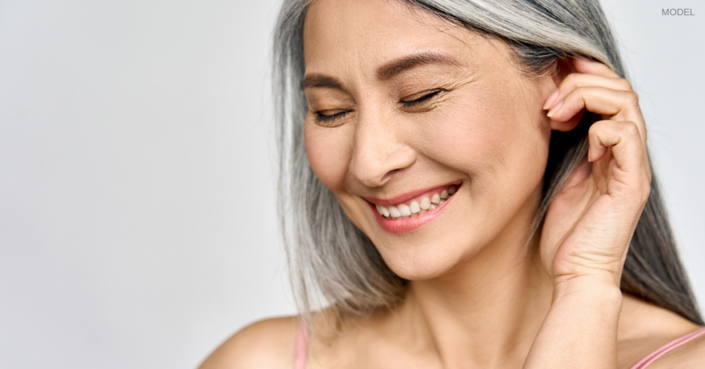 Older woman looking down and smiling