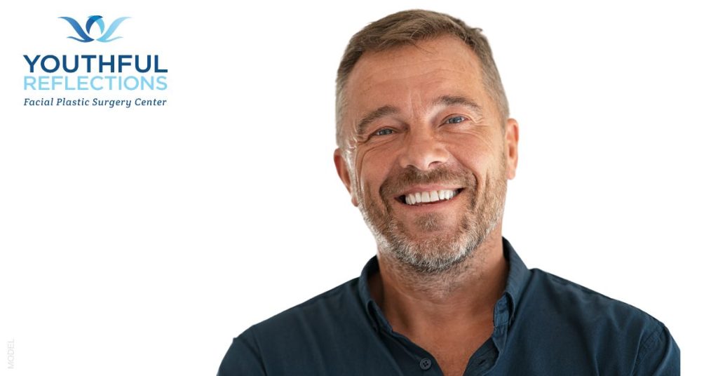 Mature man smiling in navy blue collar shirt (MODEL)