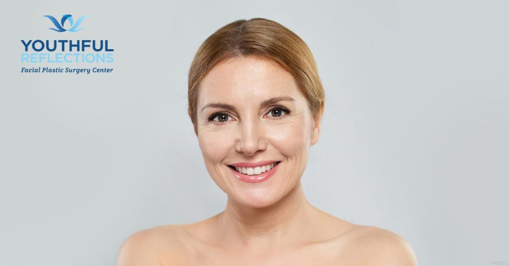 Smiling mature woman (model) Youthful Reflections: Michael A. Boggess, MD Logo