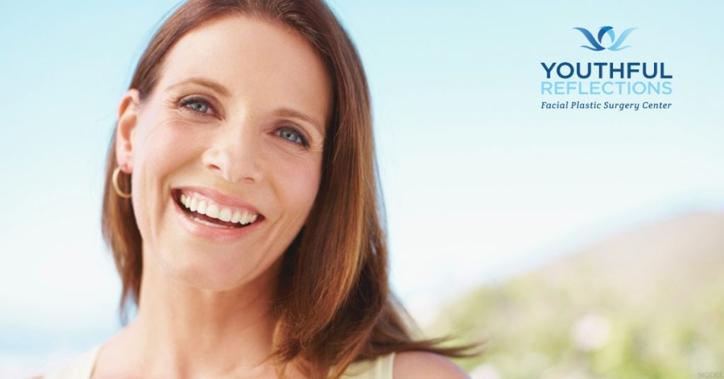 Mature woman smiling looking at the camera (MODEL) Youthful Reflections: Michael A. Boggess, MD Logo