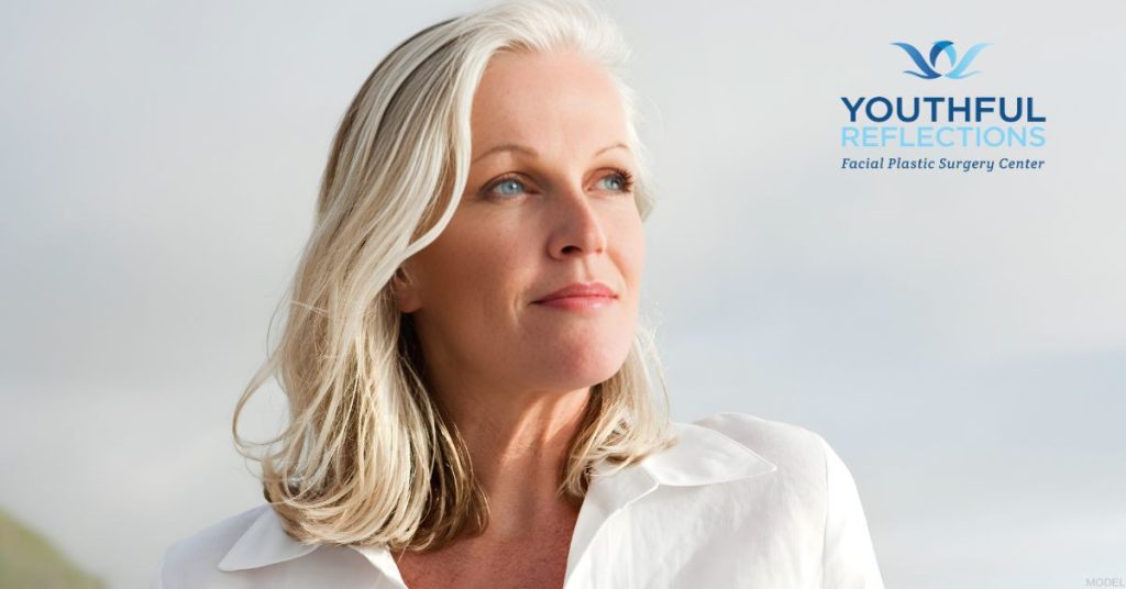 Mature woman smiling looking at the sky (MODEL) Youthful Reflections: Michael A. Boggess, MD Logo