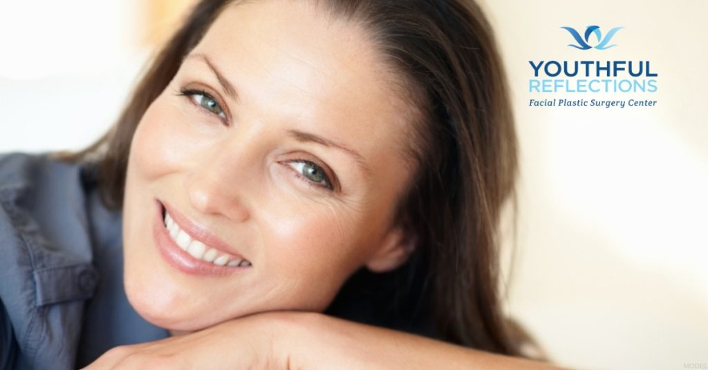 Smiling woman after eyelid surgery (model)
